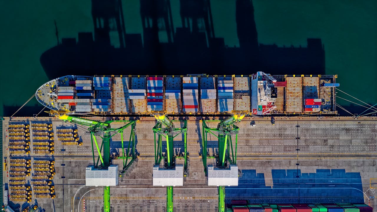 Crafting Captivating Headlines: Your awesome post title goes here High angle aerial view of a cargo ship at a bustling port in Jakarta, showcasing global trade.