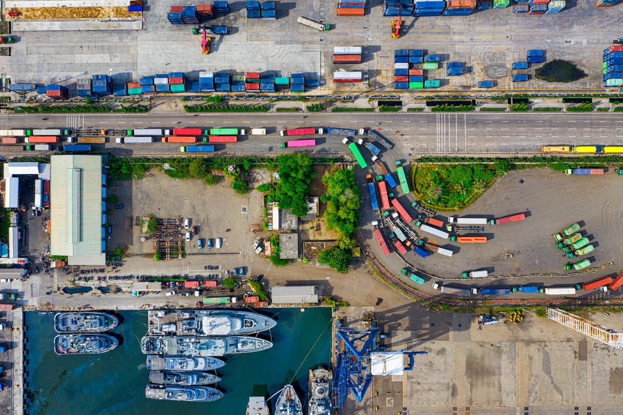 Services A vibrant aerial view of an industrial port with cargo containers in North Jakarta, Indonesia.
